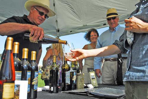 Nick Buttitta of Rosa d'Oro Vineyards in Kelseyville, Calif., pours wine for a guest at an event in Vallejo, Calif., on Saturday, August 16, 2014, while Congressman Mike Thompson and wife, Jan, look on. Photo by Mel Orpilla, district representative, Congressman Mike Thompson's office. 081614vallejobuttita