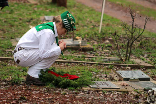 A member of the Lake County 4-H Citizenship and Leadership Project takes part in the annual Wreaths Across America commemoration at the Lower Lake Cemetery in Lower Lake, Calif., on Saturday, December 13, 2014. Photo by James Christenson. 121314wreathschild