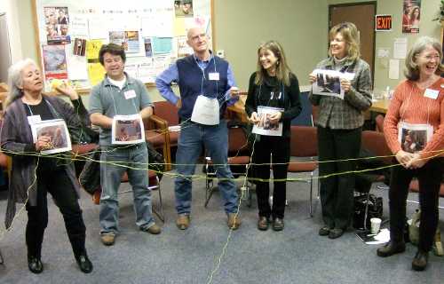 Participants have fun playing a game designed to teach how time is exchanged within a time bank at a time bank presentation in February 2013. Courtesy photo. feb2012timebanktraining