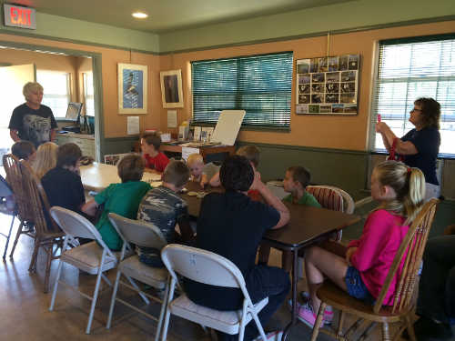 Elaine Mansell (left) talks to children on Saturday, July 19, 2014, during the summer children’s nature education program at the Lake County Land Trust’s Rodman Preserve in Lake County, Calif. Photo courtesy of the Lake County Land Trust. july2014rodmankids